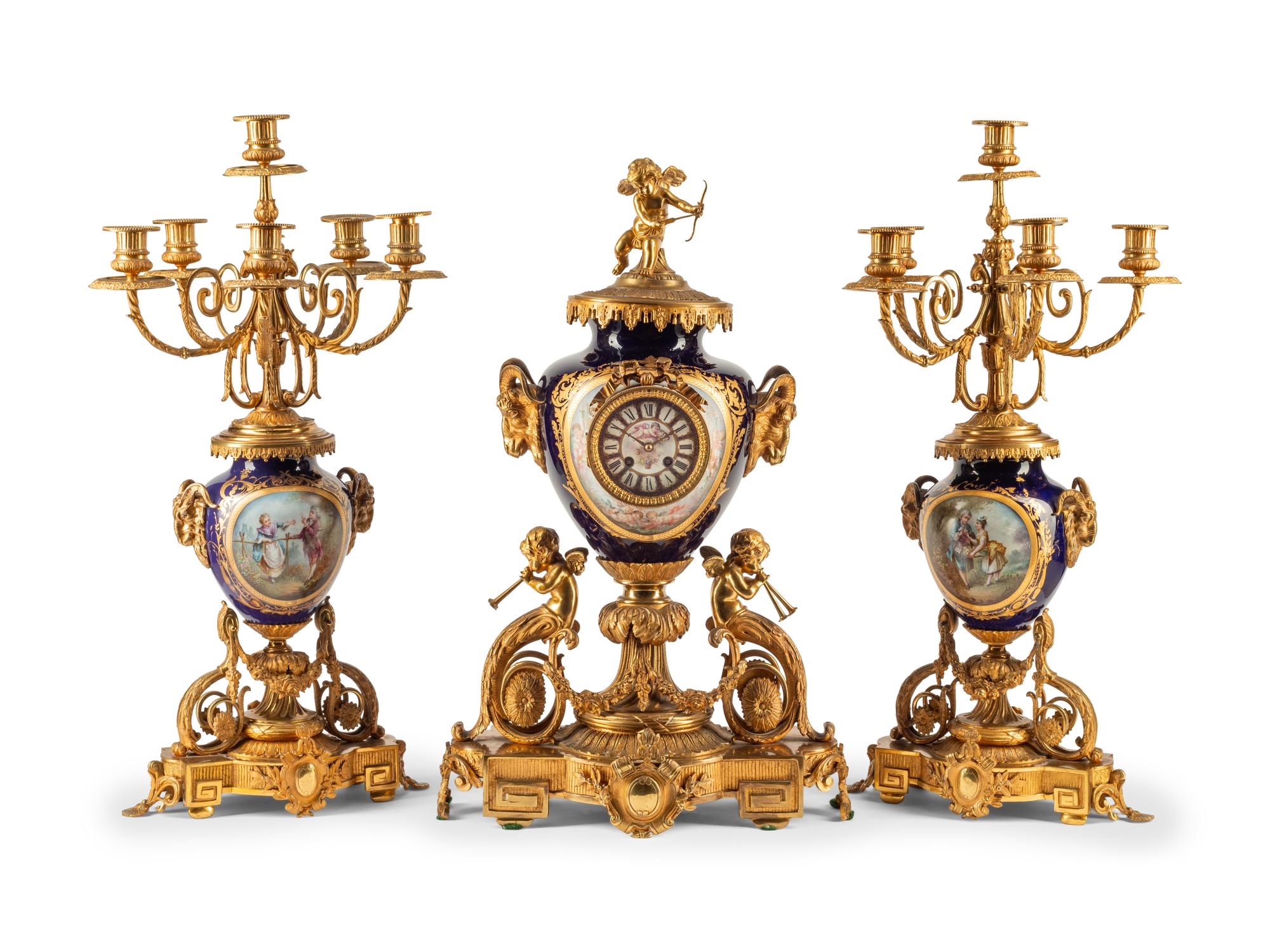 A French Gilt Bronze and Sèvres Style Porcelain Clock Garniture
