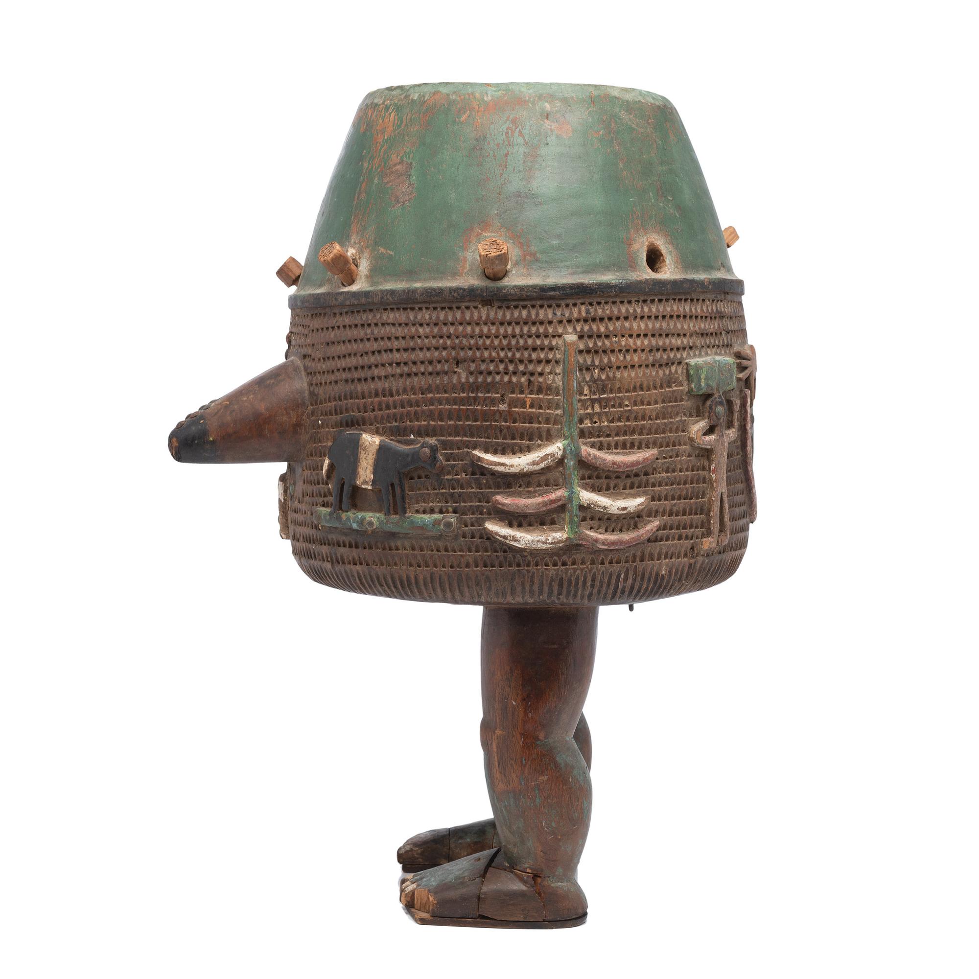 An Ashanti Carved and Gouged Painted Wood Breasted Drum