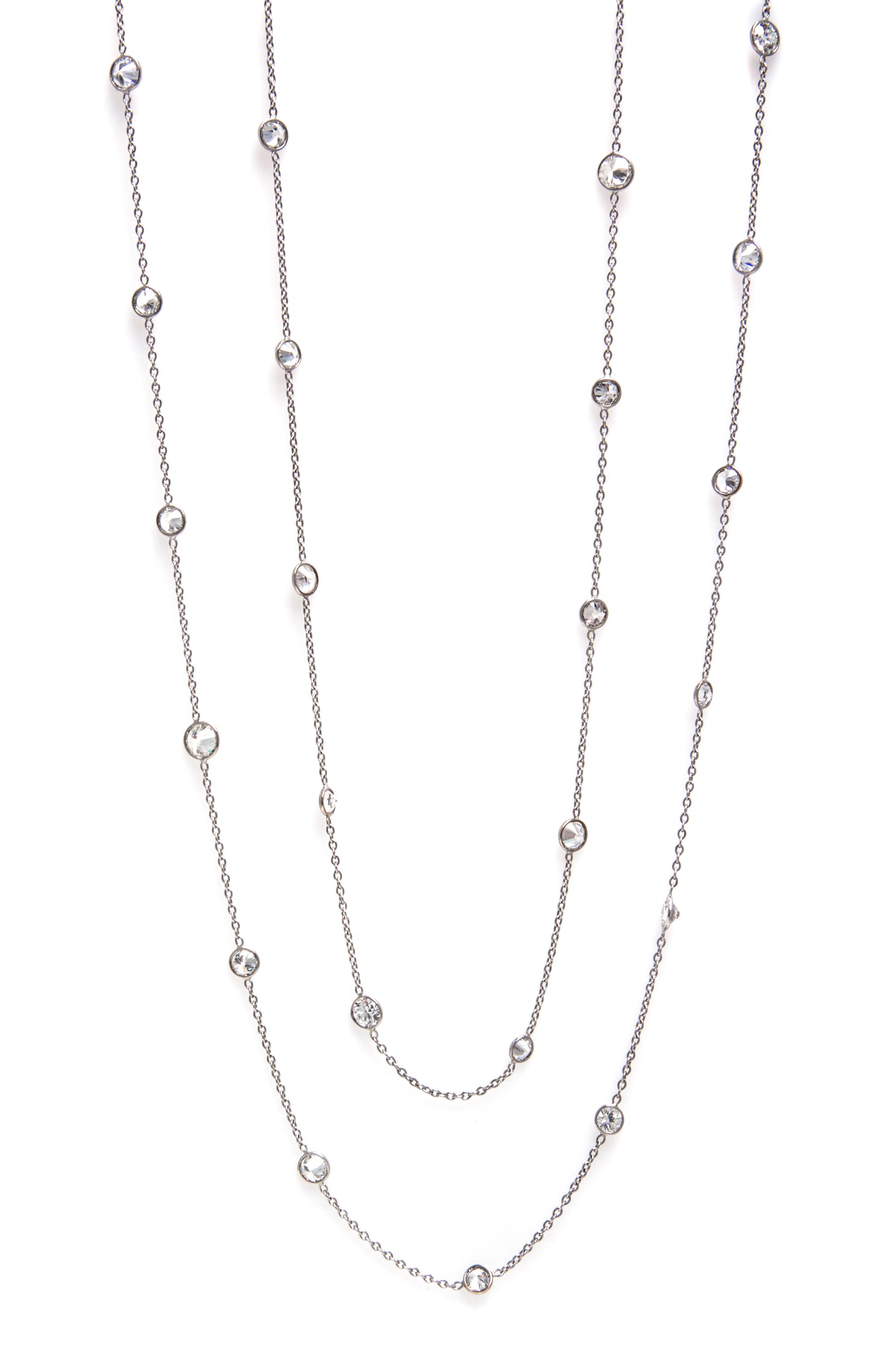 An 18 Karat White Gold and Diamond Station Necklace, 6.40 dwts.