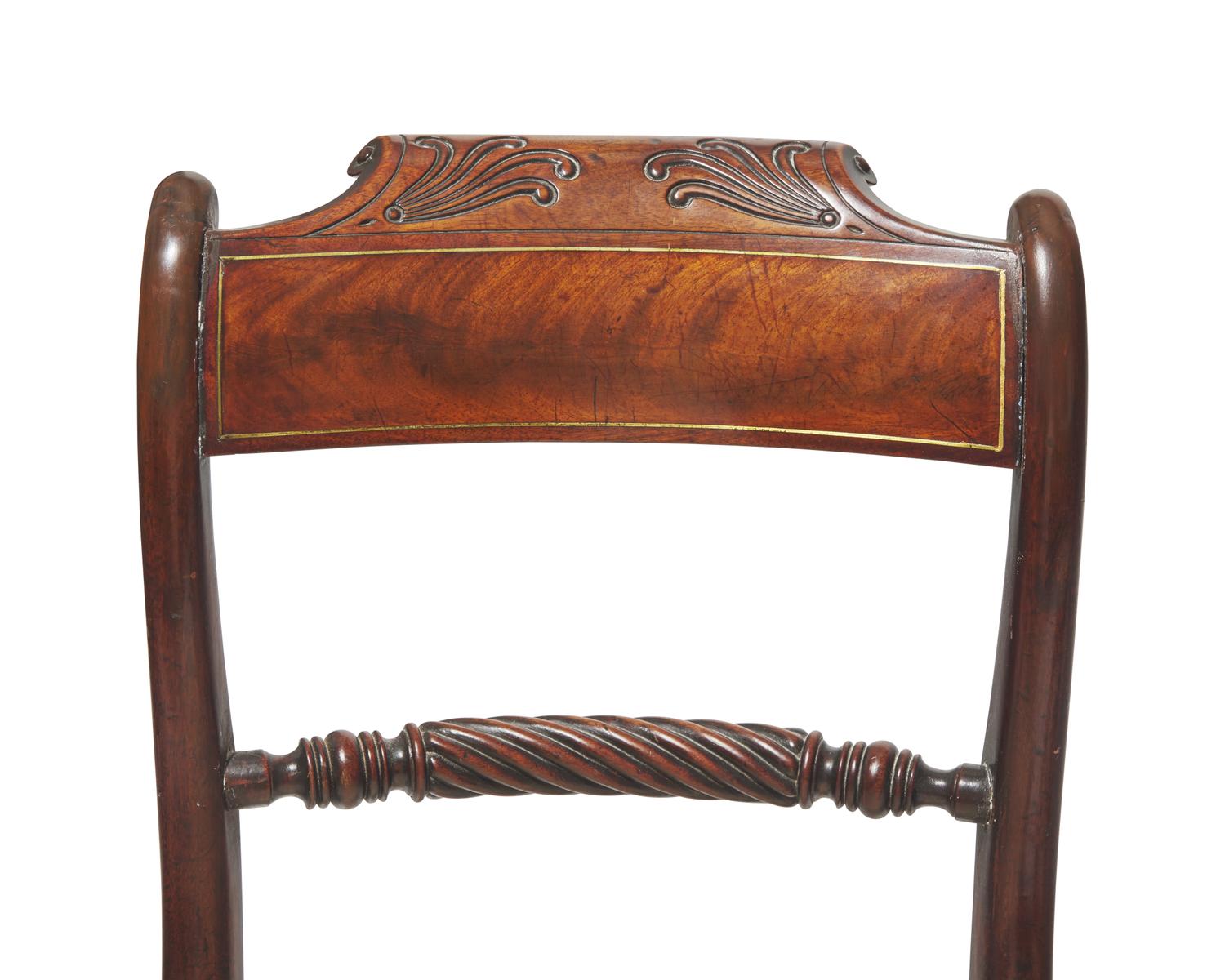 A set of eight Regency brass-inlaid mahogany side chairs, circa 1820