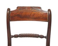 A set of eight Regency brass-inlaid mahogany side chairs, circa 1820