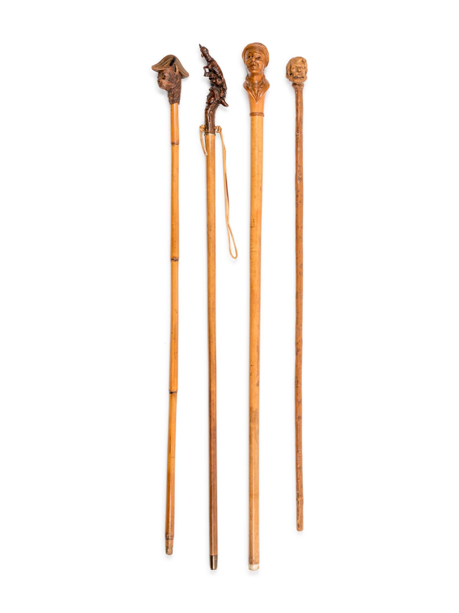 Four Figural Carved Wood Walking Sticks