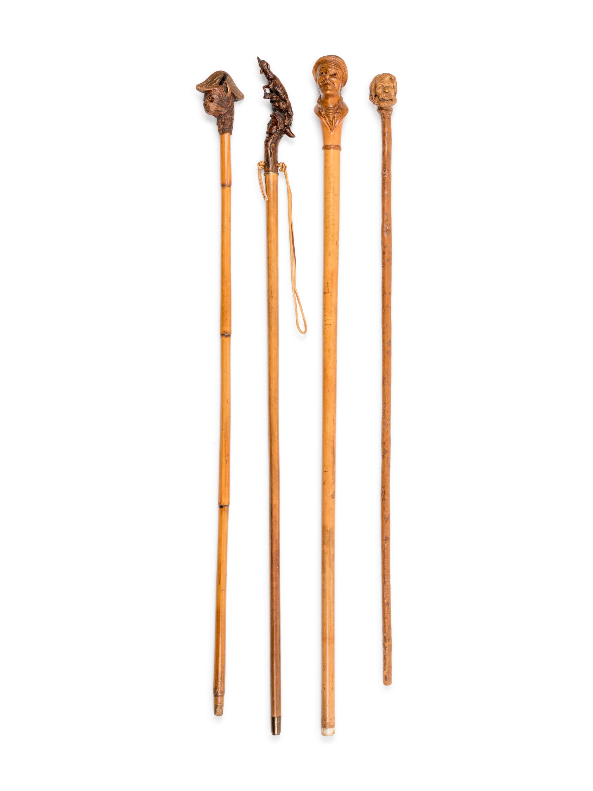 Four Figural Carved Wood Walking Sticks