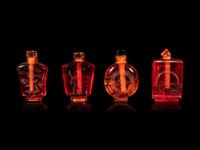 Four Chinese Amber Tone Glass Snuff Bottles