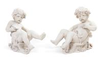 A Pair of Cast Garden Statues, Height 19 1/2 x width 19 inches.