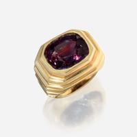 A color change alexandrite and eighteen karat gold ring