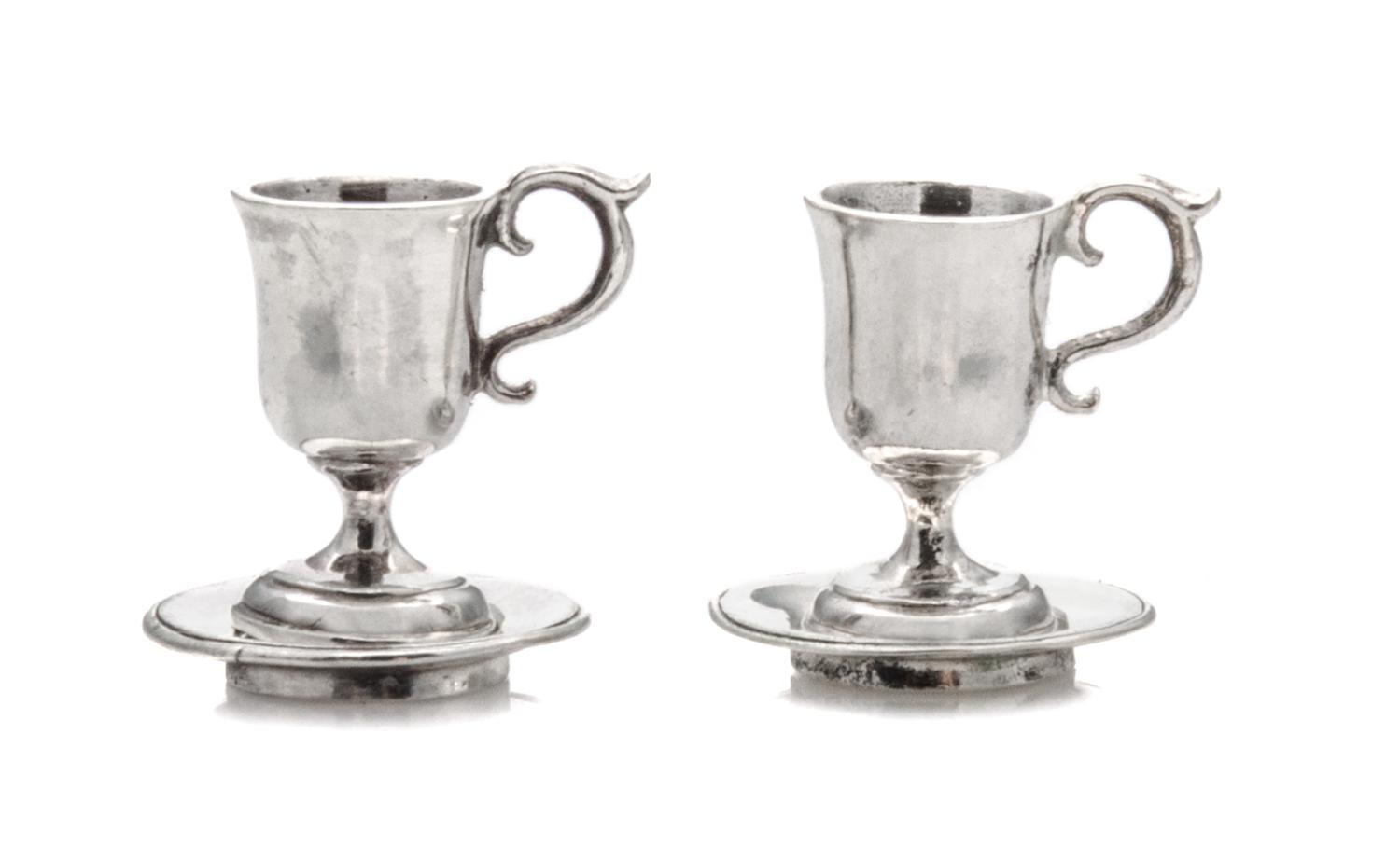 A Pair of American Silver Cups and Saucers, Obadiah Fisher, New York, NY, each having a C-scroll handle and a baluster form body surmou