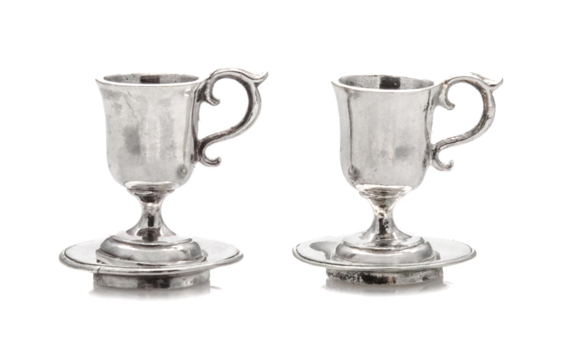A Pair of American Silver Cups and Saucers, Obadiah Fisher, New York, NY, each having a C-scroll handle and a baluster form body surmou