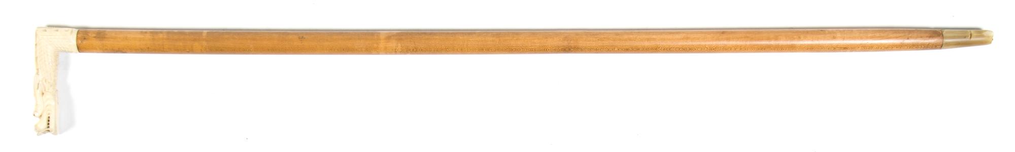 A Chinese Carved Ivory Cane Handle, Height overall 34 x width of handle 3 7/8 inches.