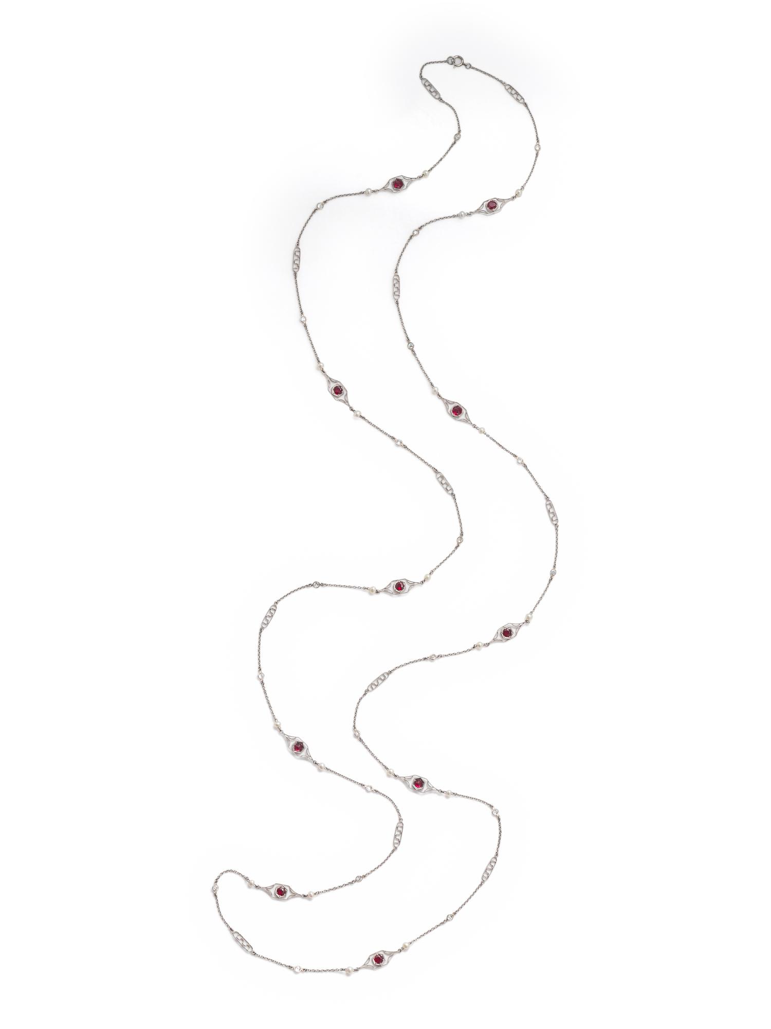 PLATINUM, DIAMOND, SEED PEARL AND SYNTHETIC RUBY LONGCHAIN NECKLACE