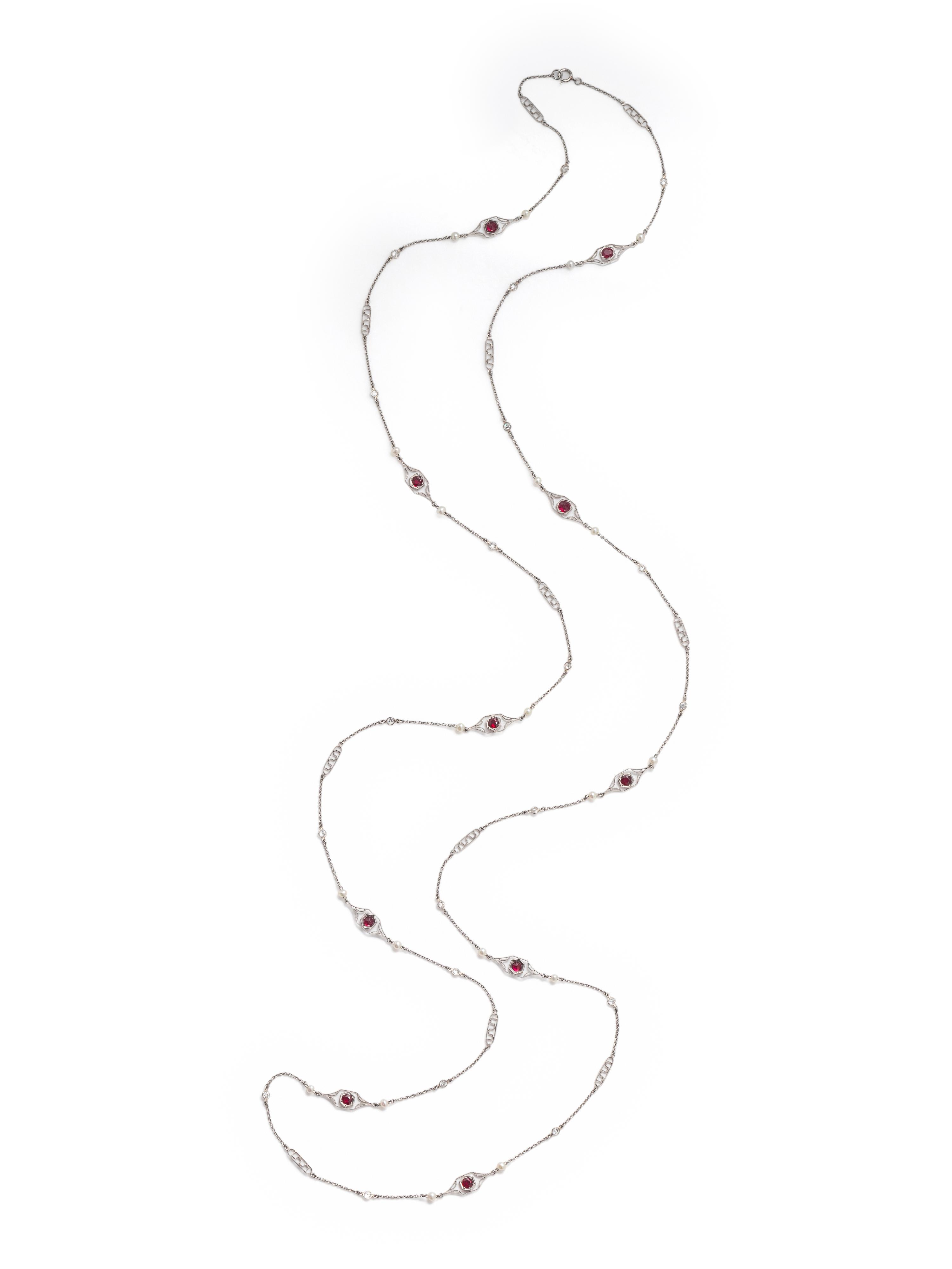 PLATINUM, DIAMOND, SEED PEARL AND SYNTHETIC RUBY LONGCHAIN NECKLACE