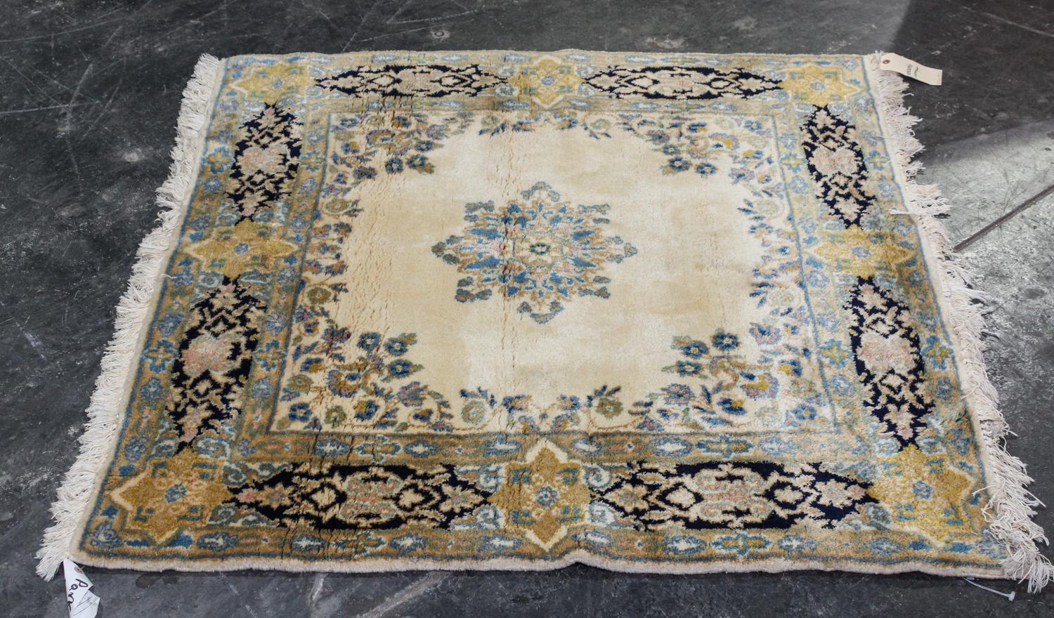 A Persian Wool Mat. 4 feet 1 inch x 4 feet 1 inch.