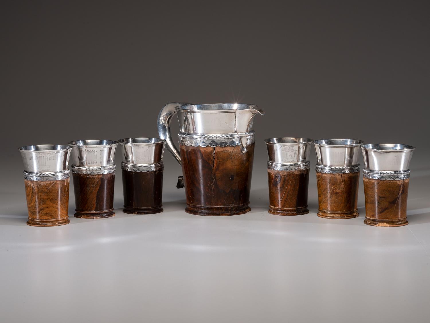 A Silver Mounted Mahogany Pitcher and Six Cups