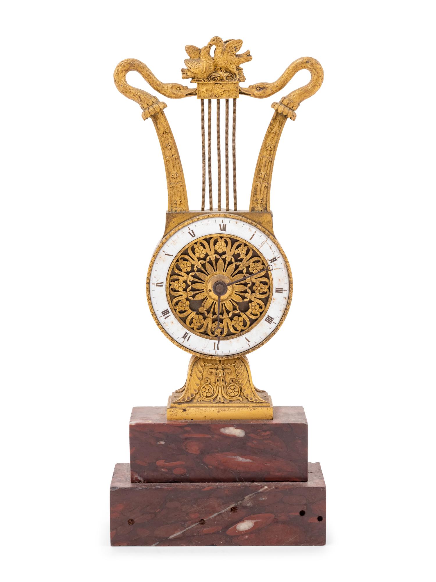 An Empire Style Gilt Bronze and Rouge Marble Clock