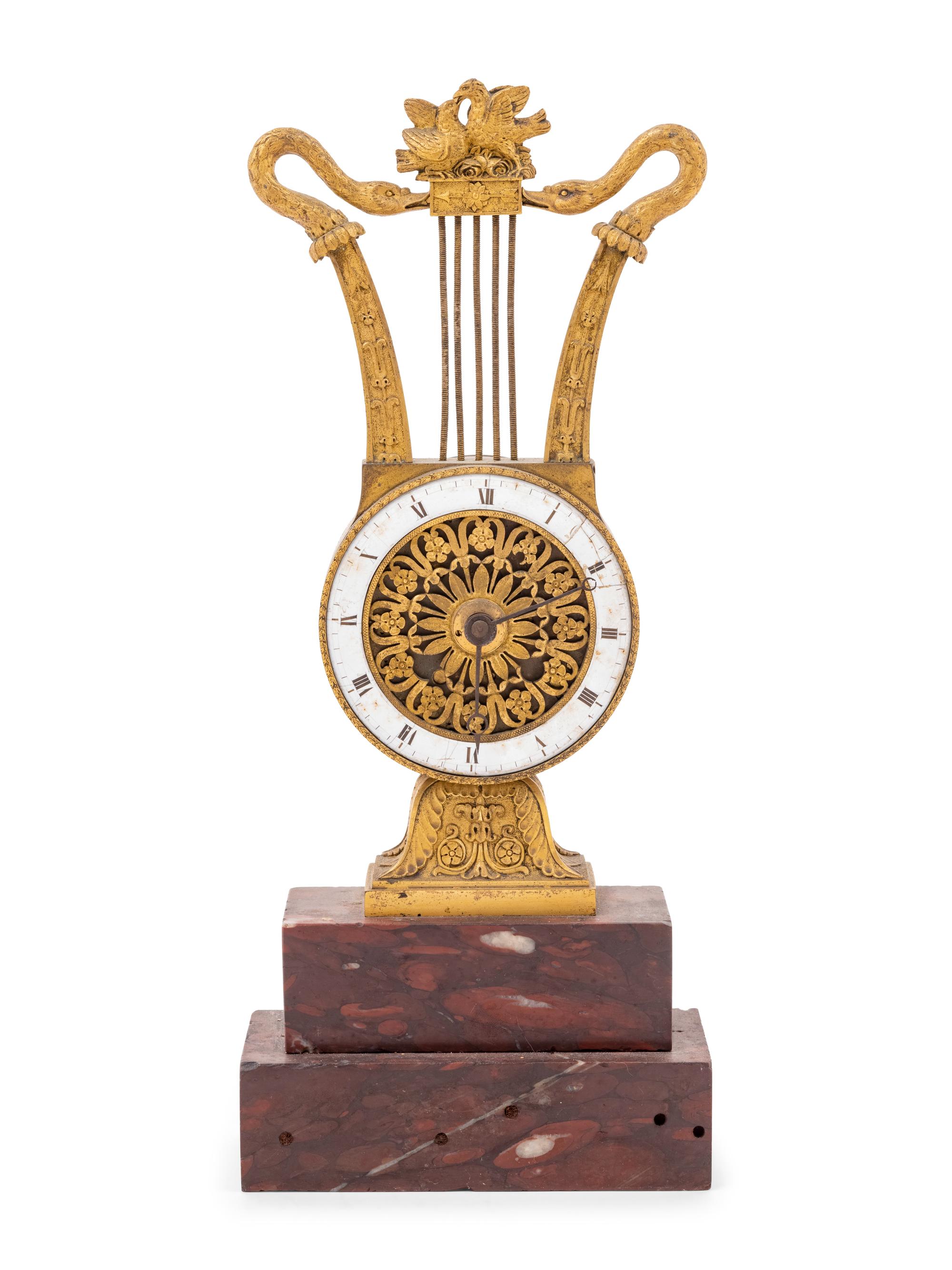 An Empire Style Gilt Bronze and Rouge Marble Clock