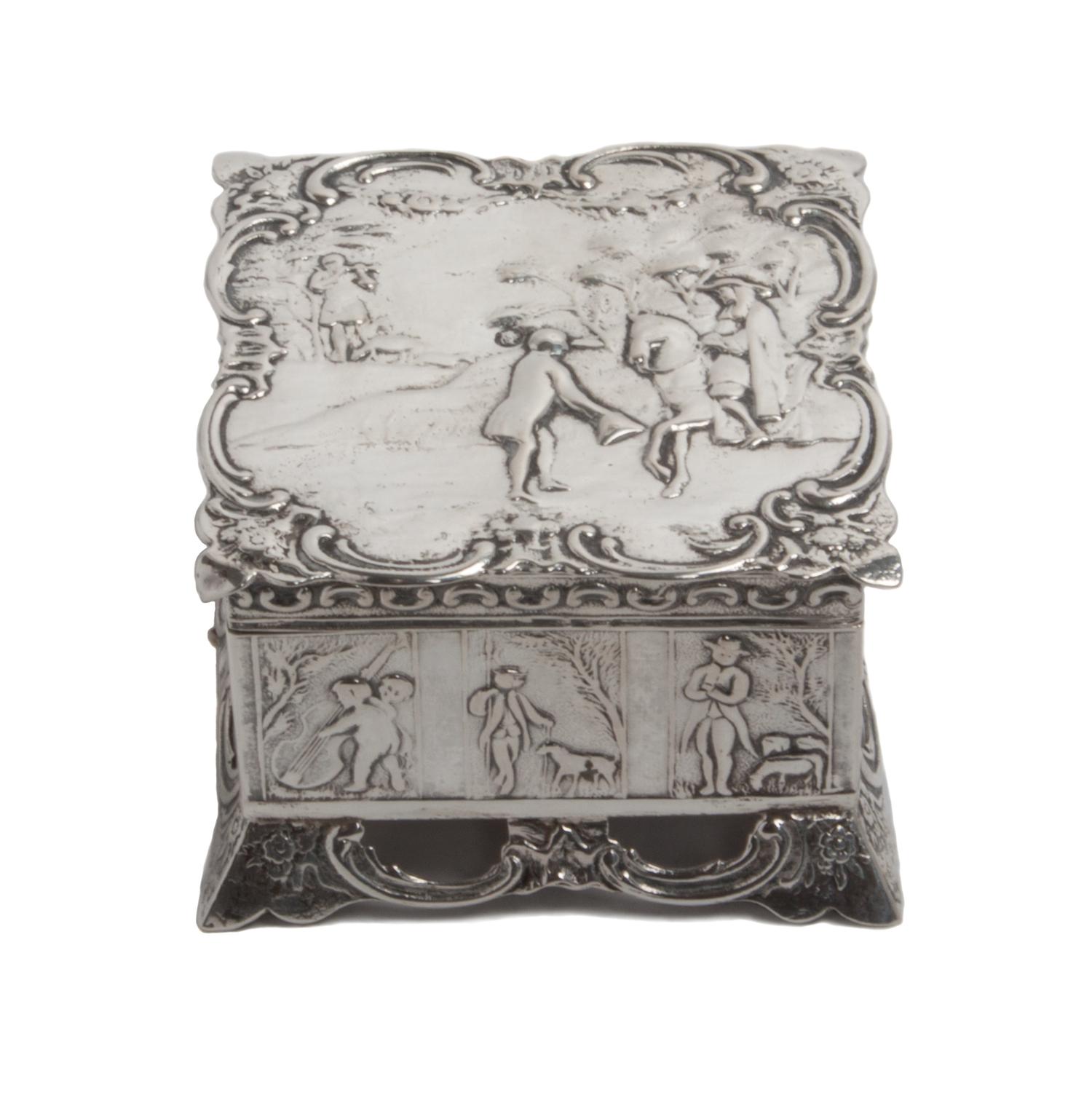 A Dutch Silver Box, , of square form, having allover chased designs, the hinged lid depicting a landscape with a figure on horseback wi
