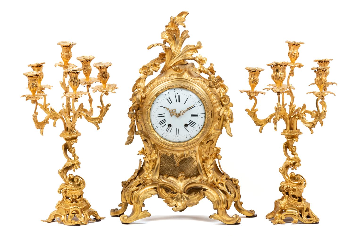 A Louis XV Style Gilt Bronze Three-Piece Clock Garniture