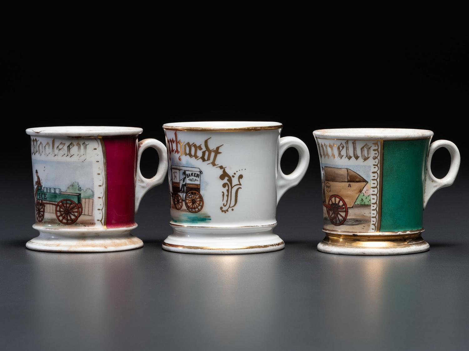 Three Porcelain Occupational Shaving Mugs with Horse-Drawn Carts