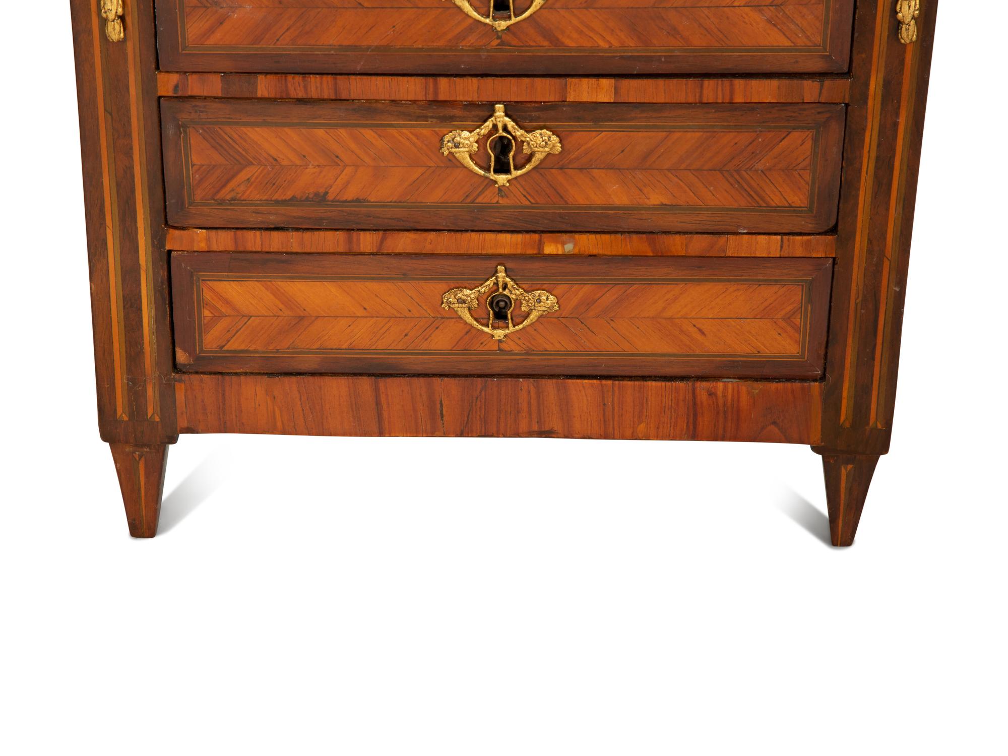 A Louis XVI Diminutive Marble-Top Four Drawer Chiffonier