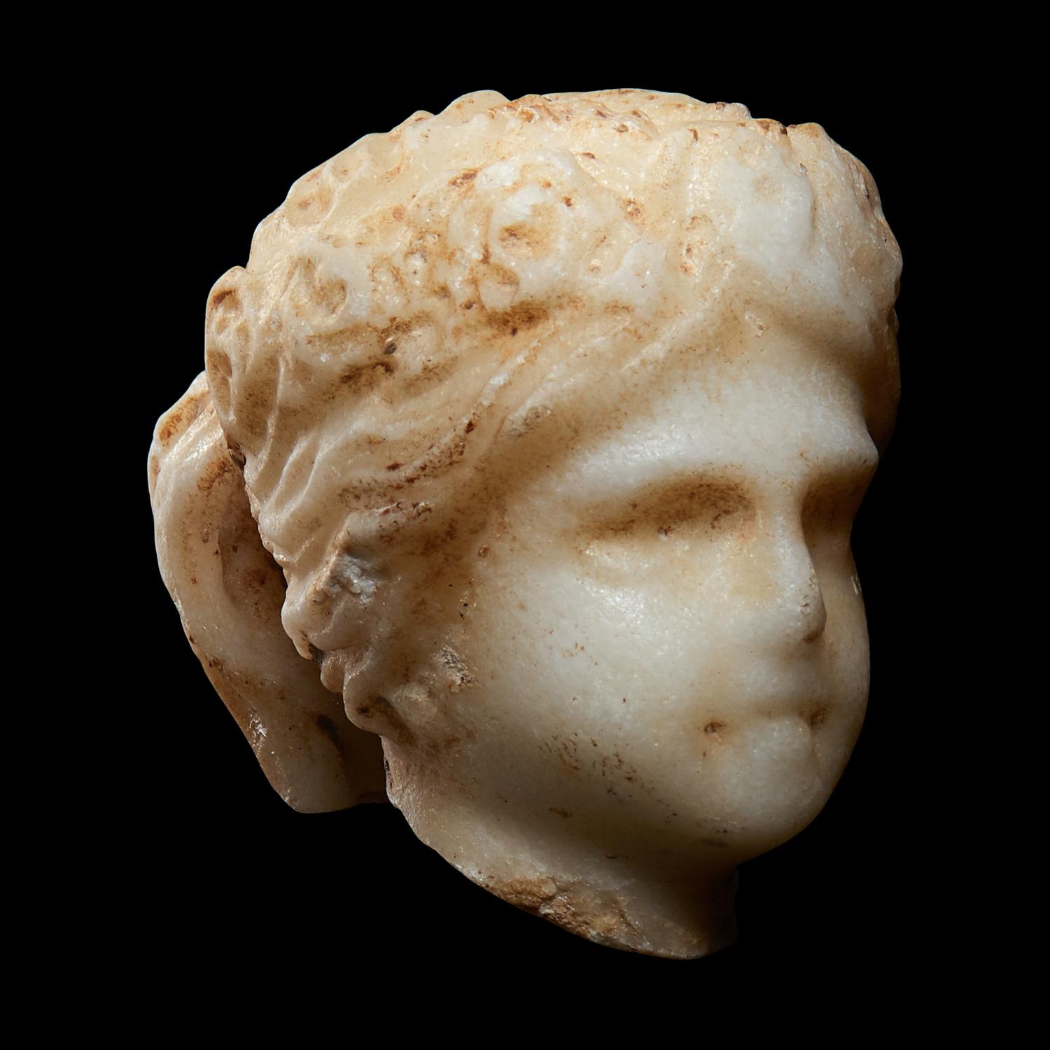 A Roman Marble Head of a Muse, Possibly Flora