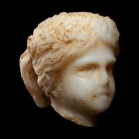 A Roman Marble Head of a Muse, Possibly Flora