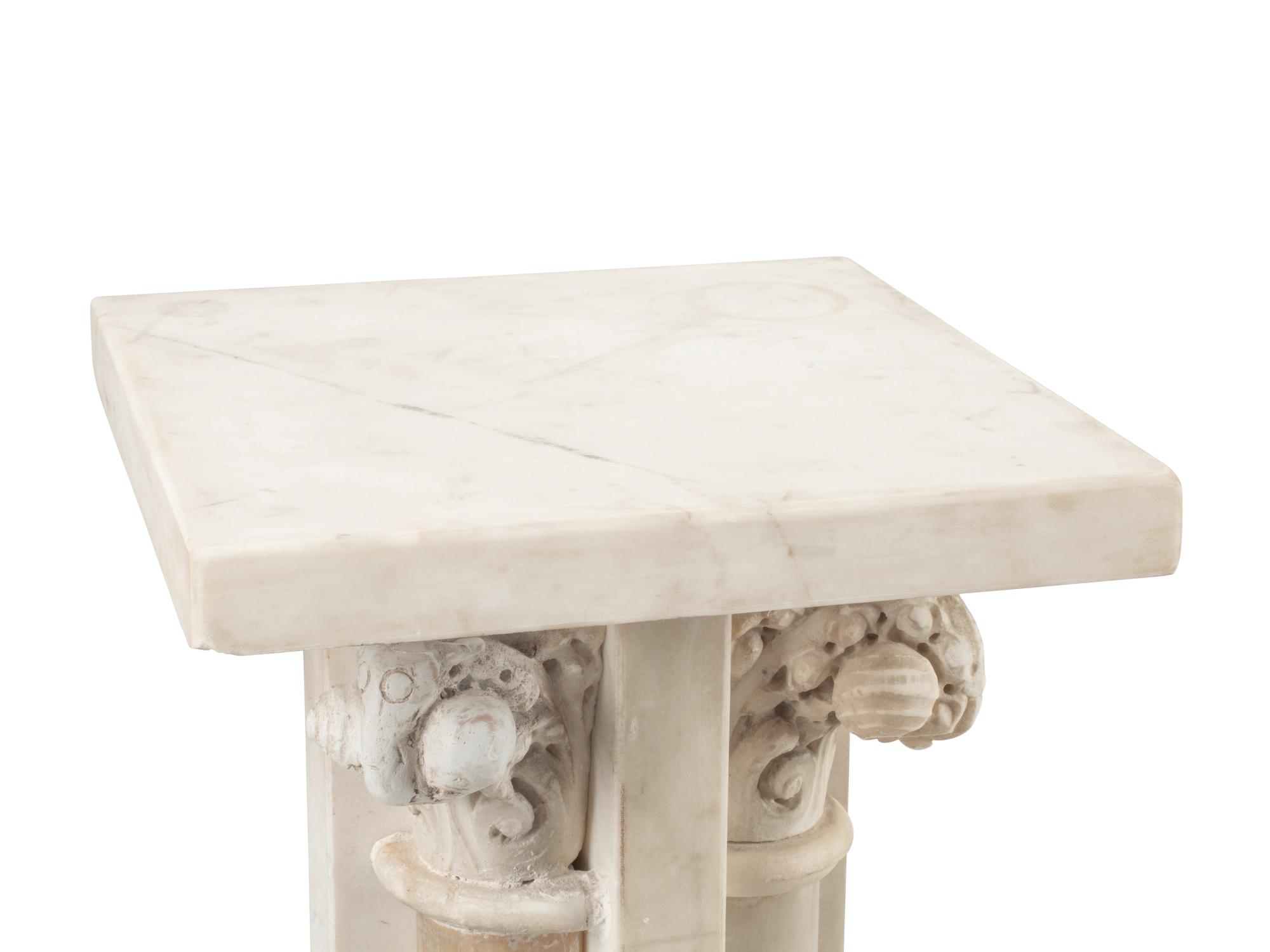 A Pair of Continental Carved Marble and Onyx Quadripartite Pedestals