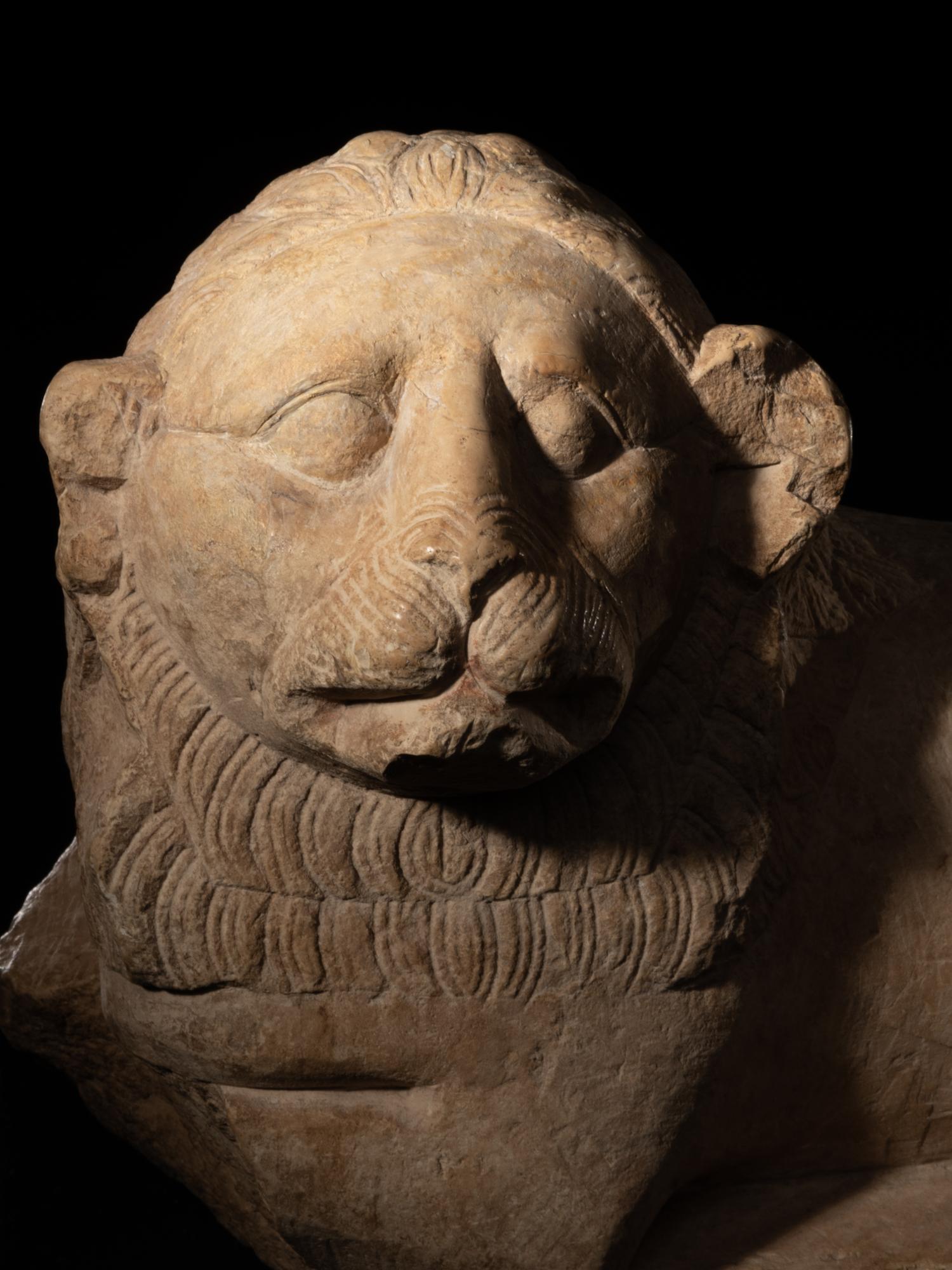 An Egyptian Limestone Recumbent Lion