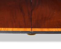 A Regency style two-pedestal inlaid mahogany and satinwood dining table, 20th century