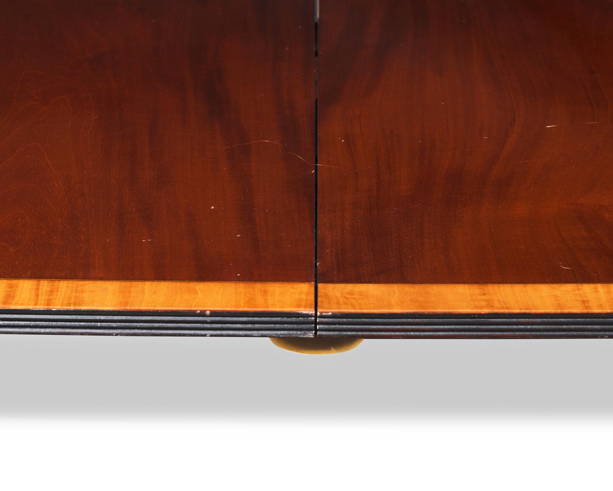 A Regency style two-pedestal inlaid mahogany and satinwood dining table, 20th century