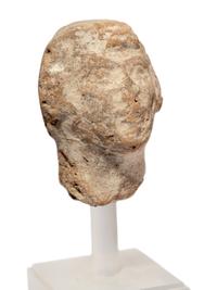 A Near Eastern Terracotta Figure and a Head