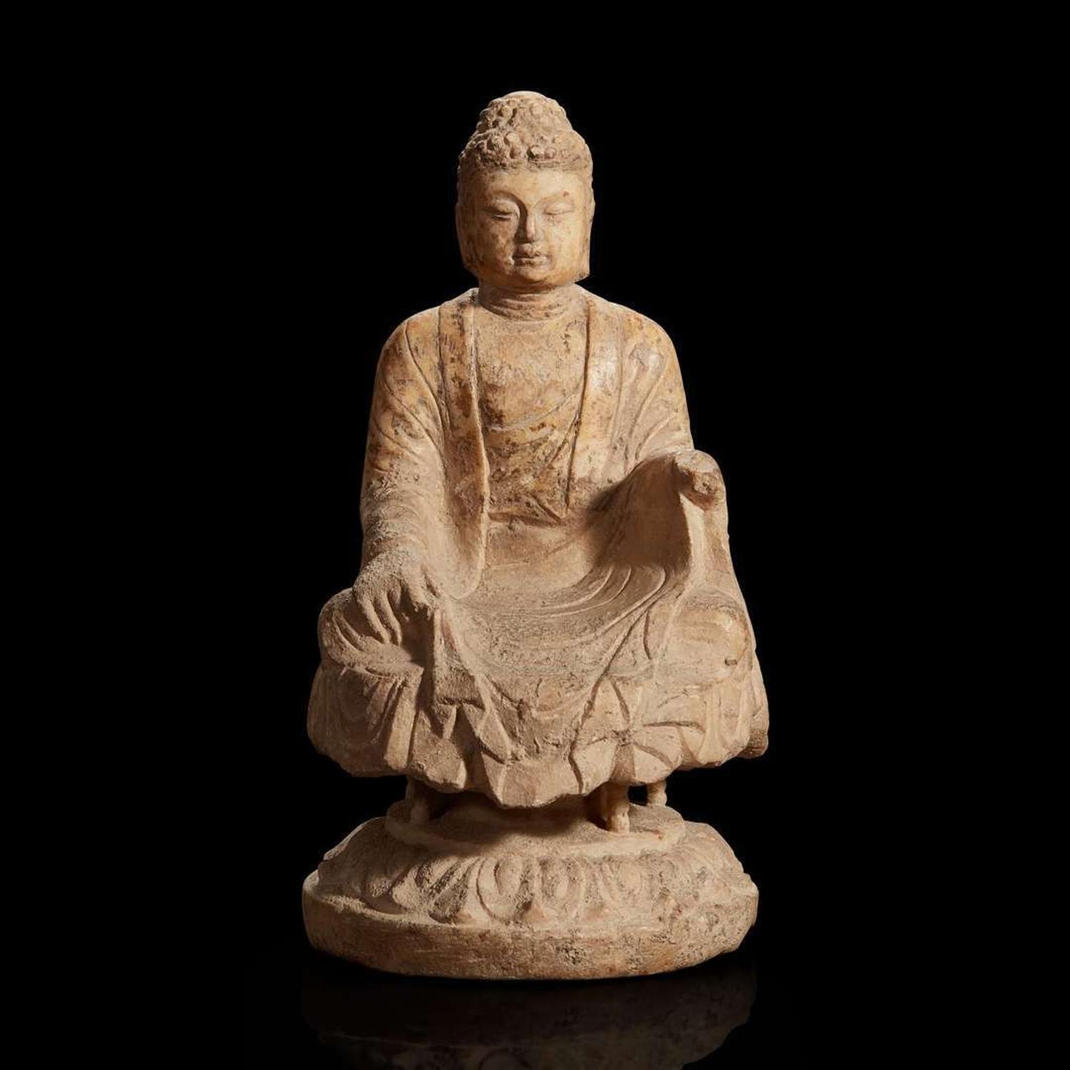 A Chinese carved white marble figure of Buddha seated