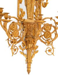 A Pair of Large Louis XVI Style Mirrored Gilt Bronze Figural Sconces