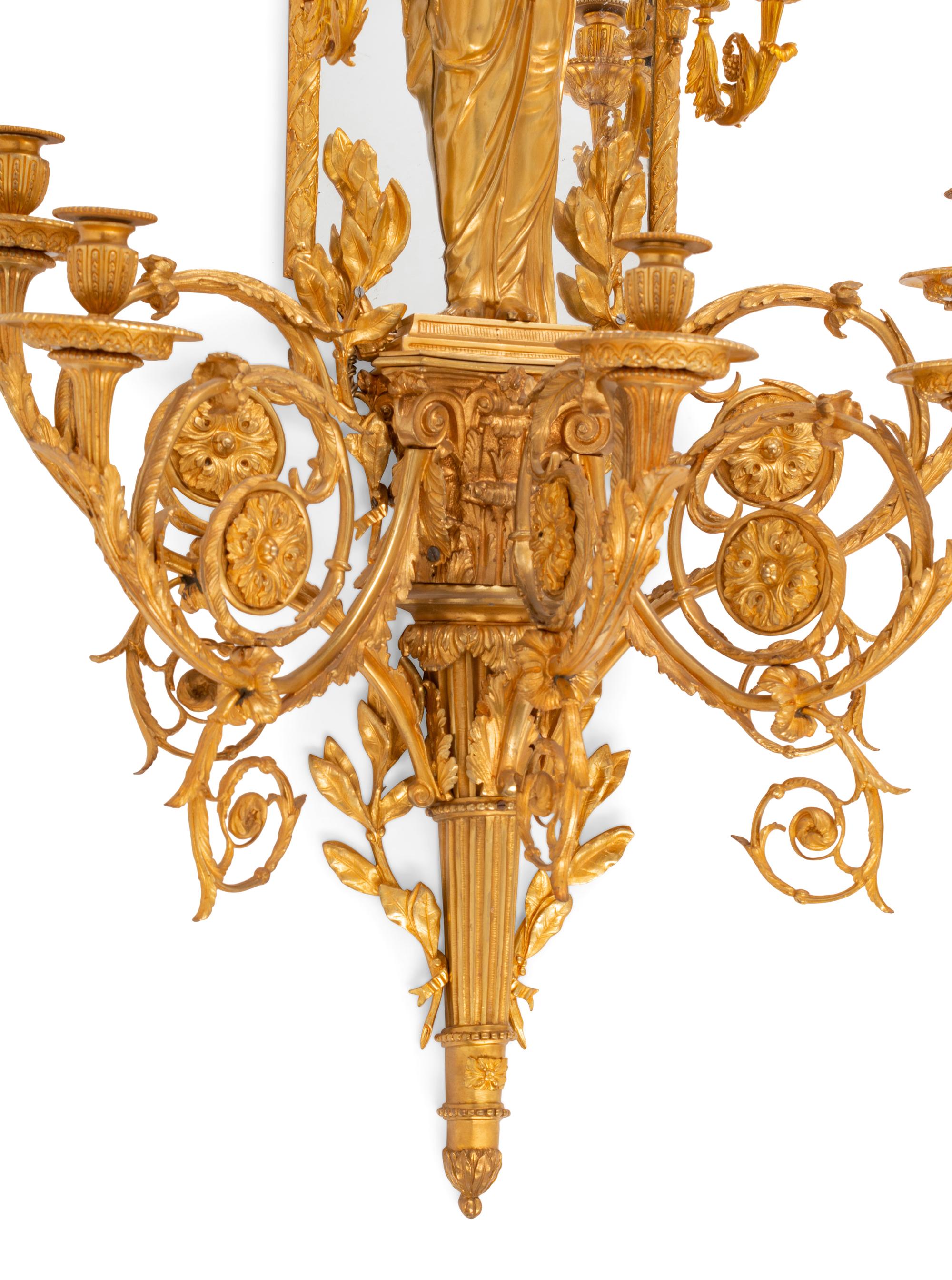 A Pair of Large Louis XVI Style Mirrored Gilt Bronze Figural Sconces