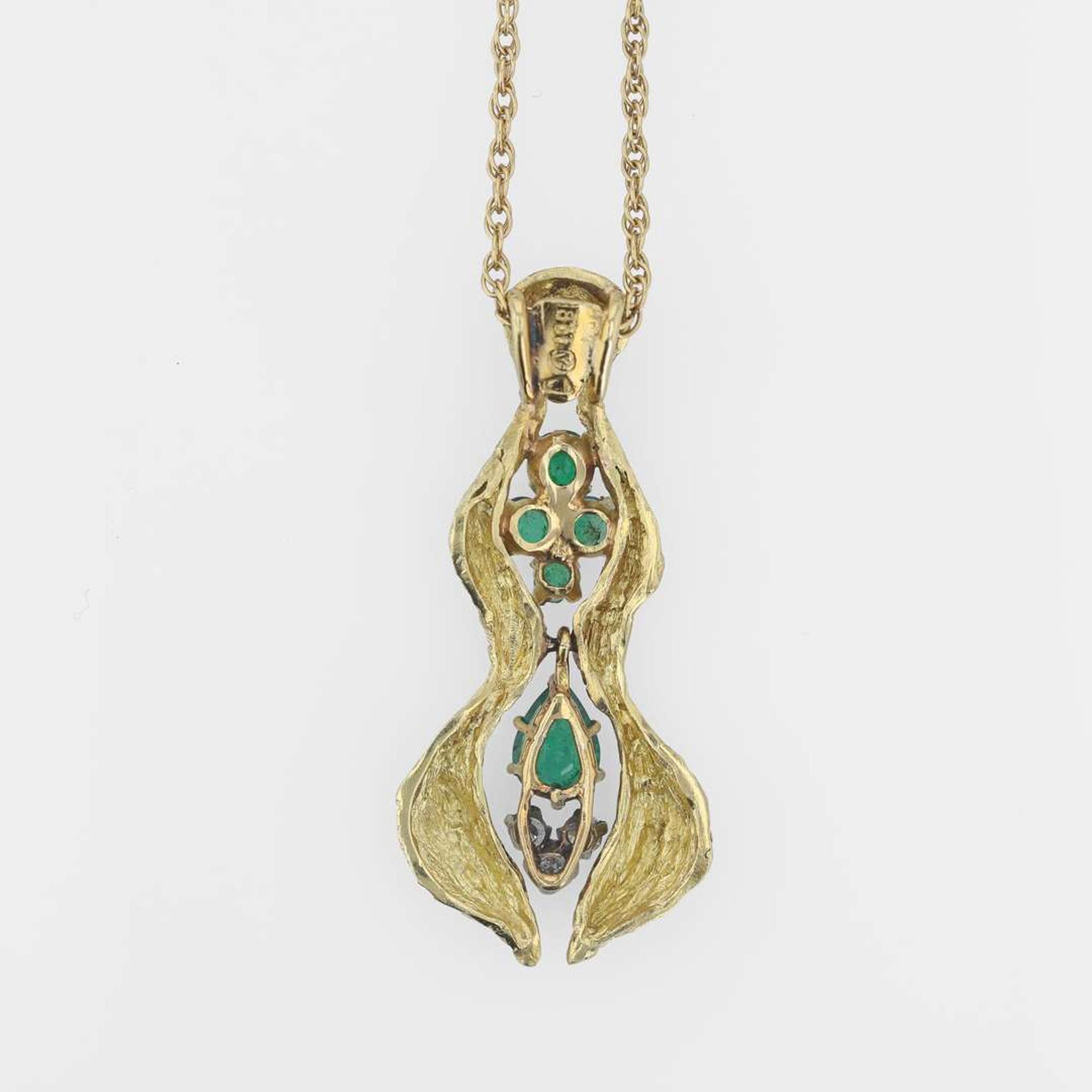 An 18K yellow gold, emerald, and diamond necklace