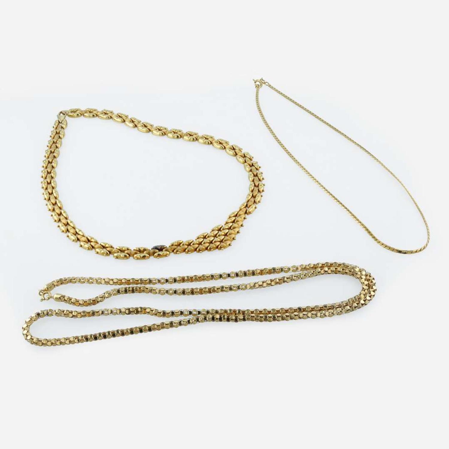 A group of gold necklaces