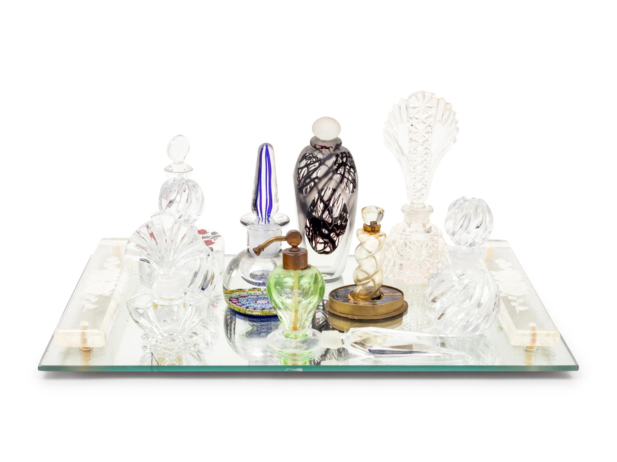 A Collection of Eleven Glass Perfume Bottles and a Mirrored Glass Tray