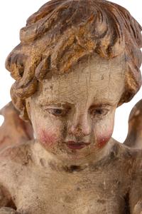 A Continental Painted and Parcel Gilt Cherub Ornament