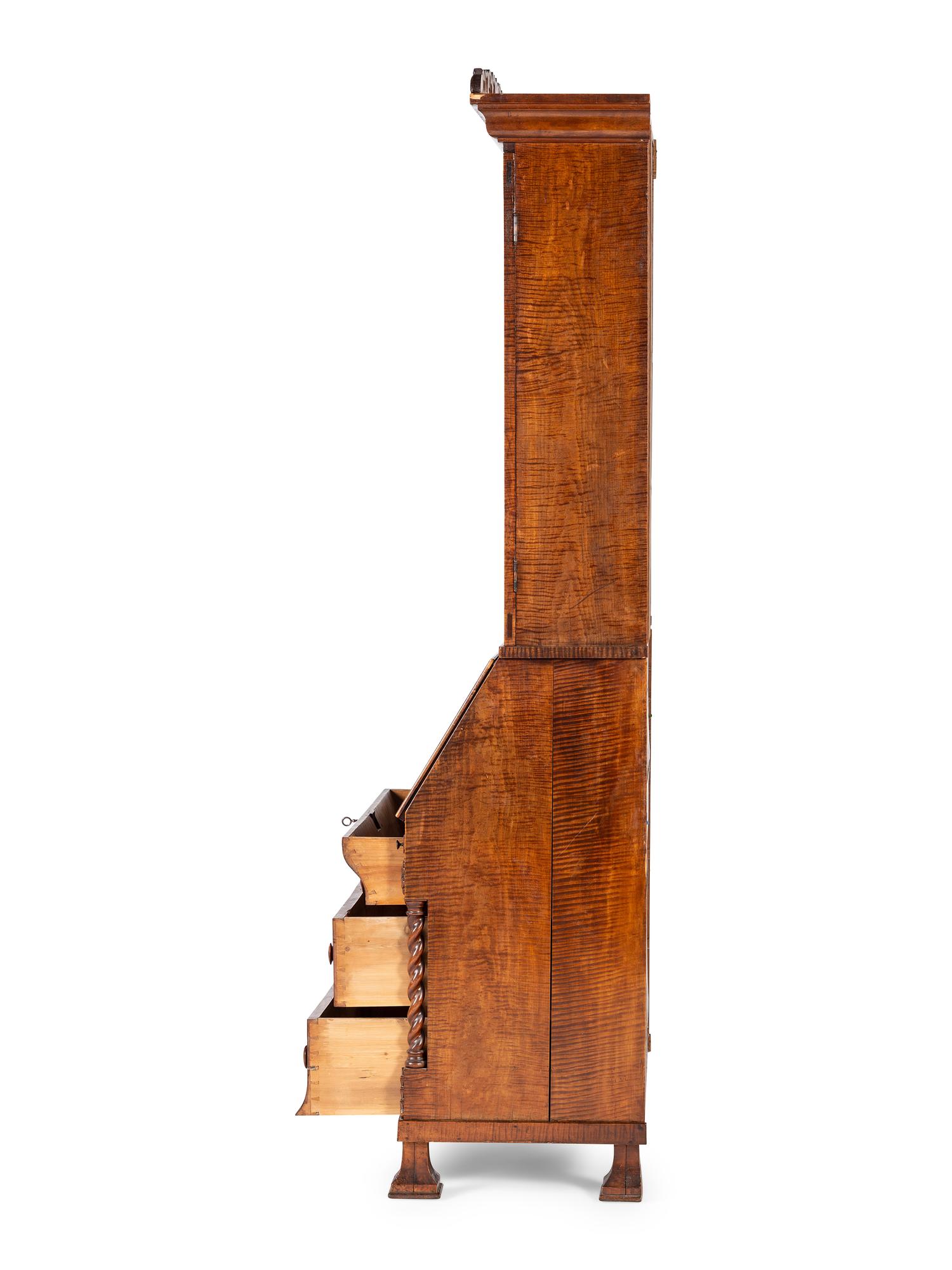 A Classical Style Carved and Highly Figured Tiger Maple Slant Front Desk