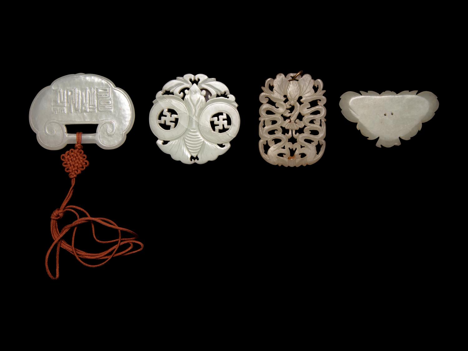 Four Chinese Pale Celadon Jade Pendants