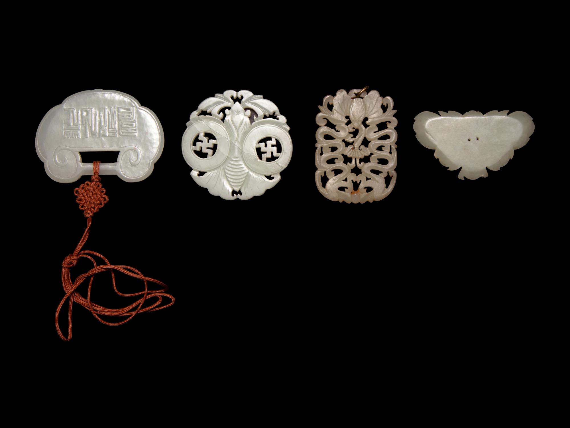 Four Chinese Pale Celadon Jade Pendants