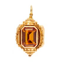 A Rose Gold and Synthetic Orange Sapphire Charm,