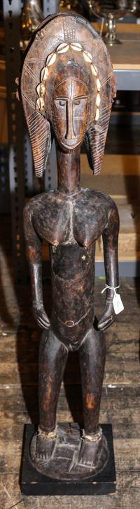 A Bamana Carved Wood Figure of a Standing Female Height 41 1/2 x width 7 3/4 x depth 7 inches. — 20TH CENTURY
