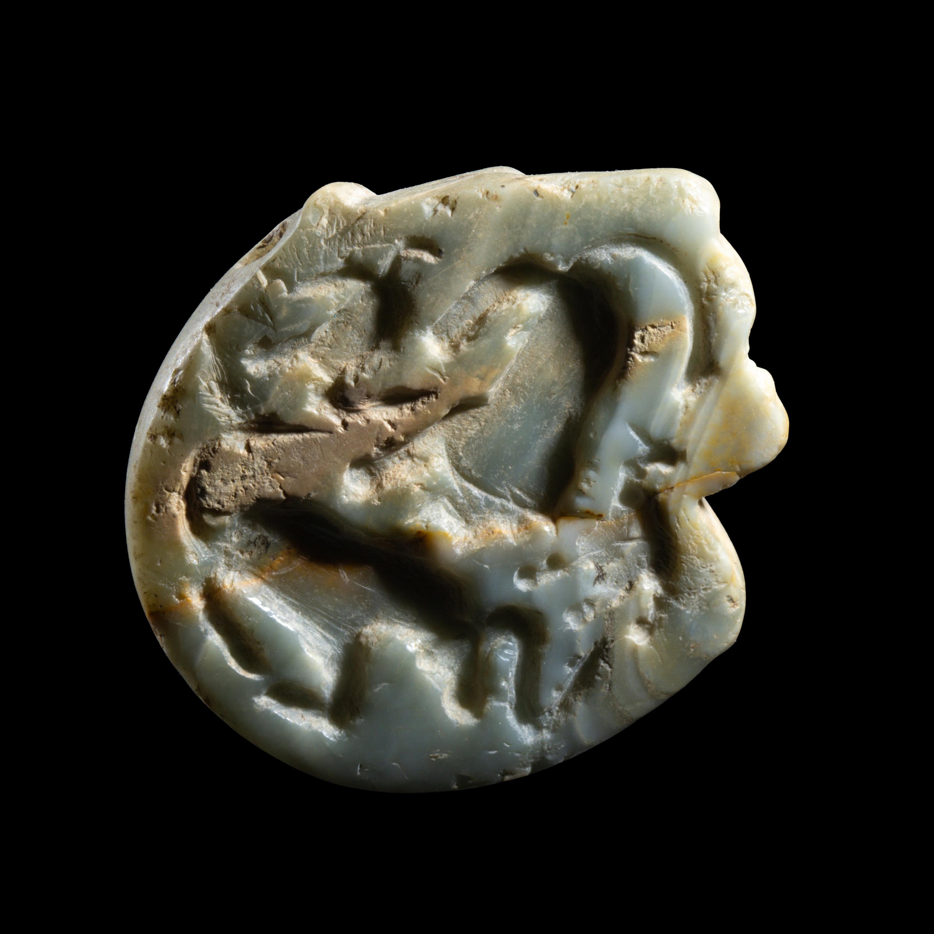 A Mesopotamian Green Stone Seal with a Lion Head
