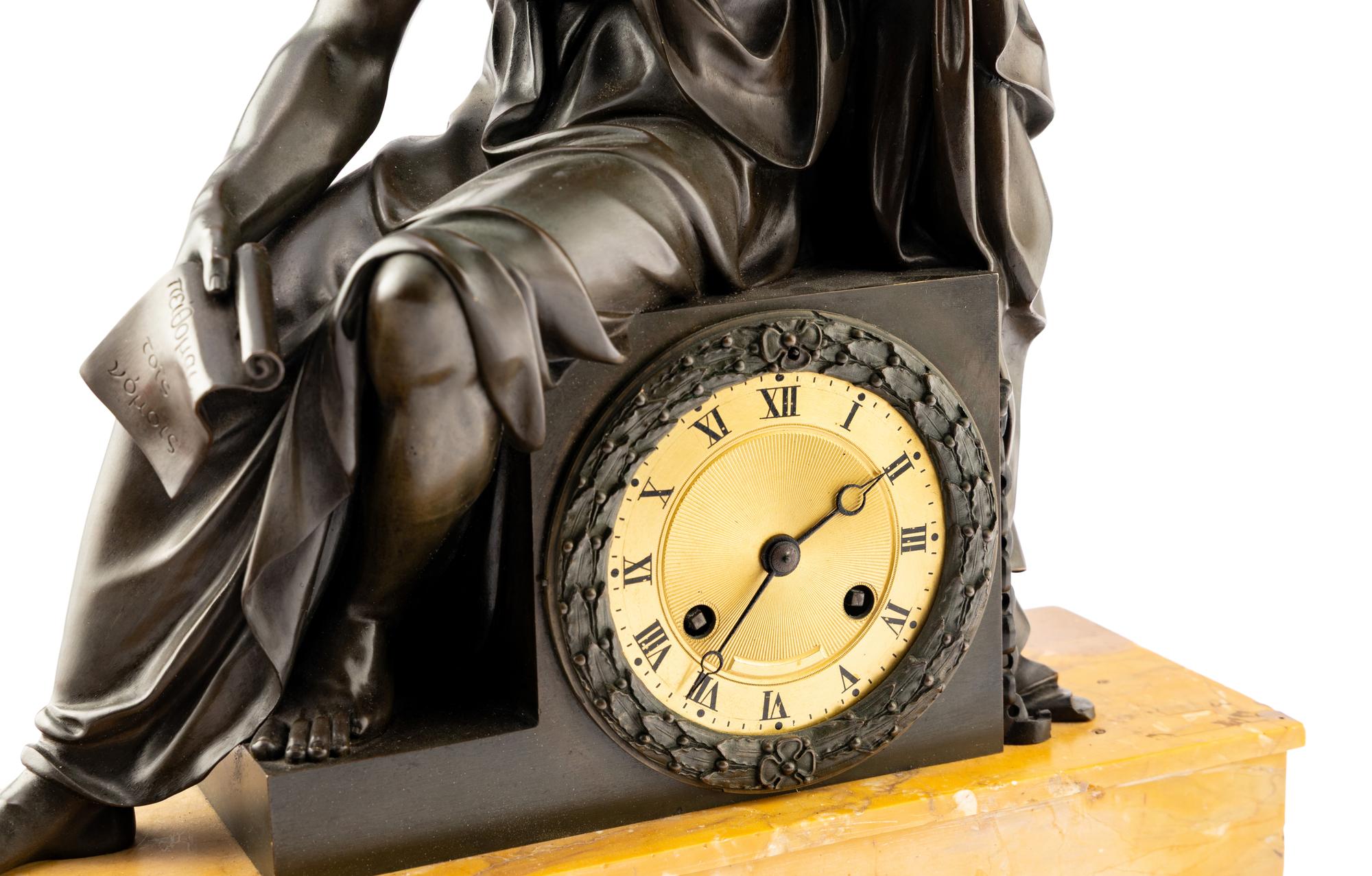 A Louis Philippe Patinated Bronze and Sienna Marble Figural Mantel Clock