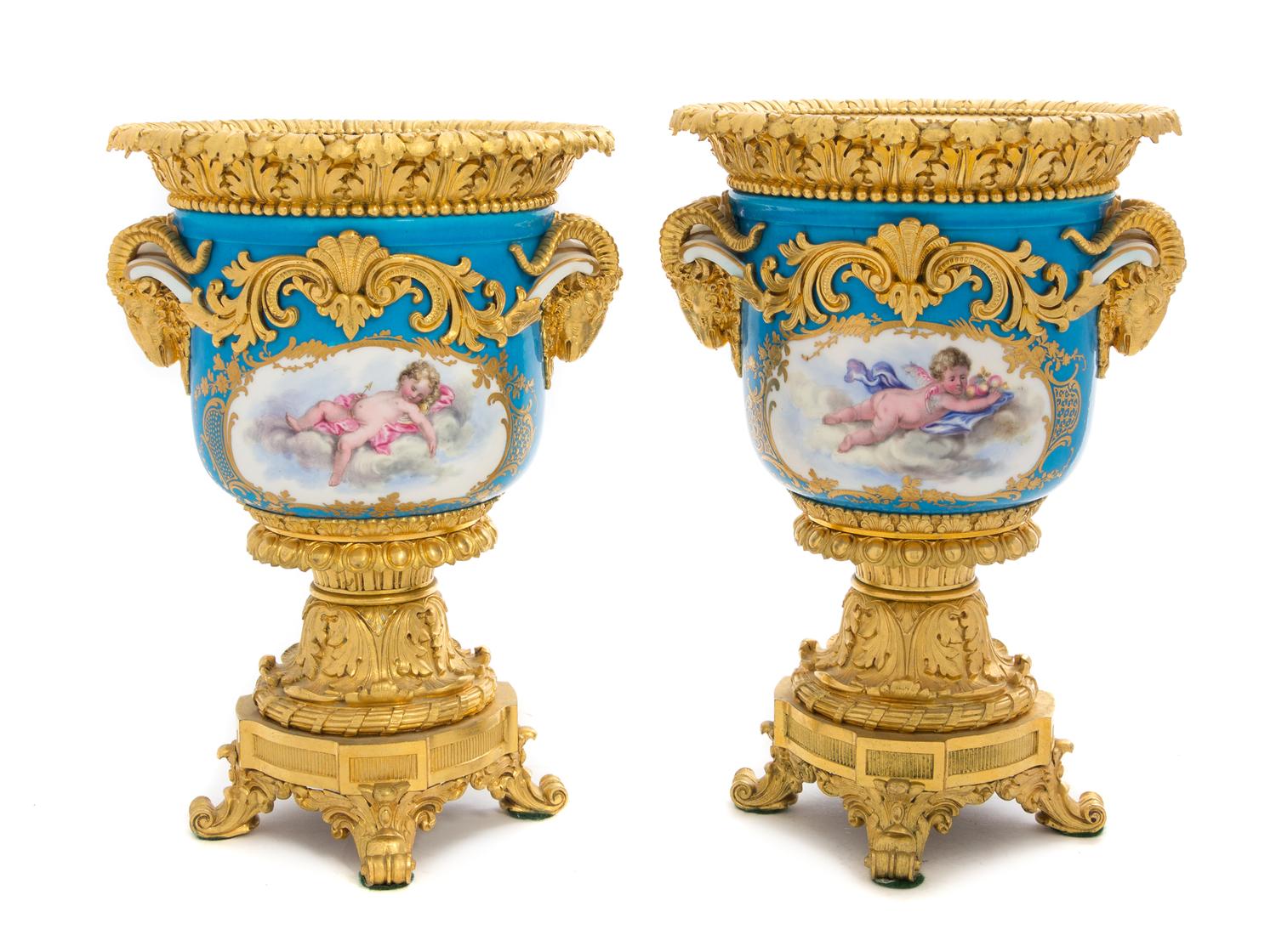 A Pair of Gilt Bronze Mounted Sevres Porcelain Urns Height 10 1/2 inches.