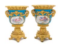 A Pair of Gilt Bronze Mounted Sevres Porcelain Urns Height 10 1/2 inches.
