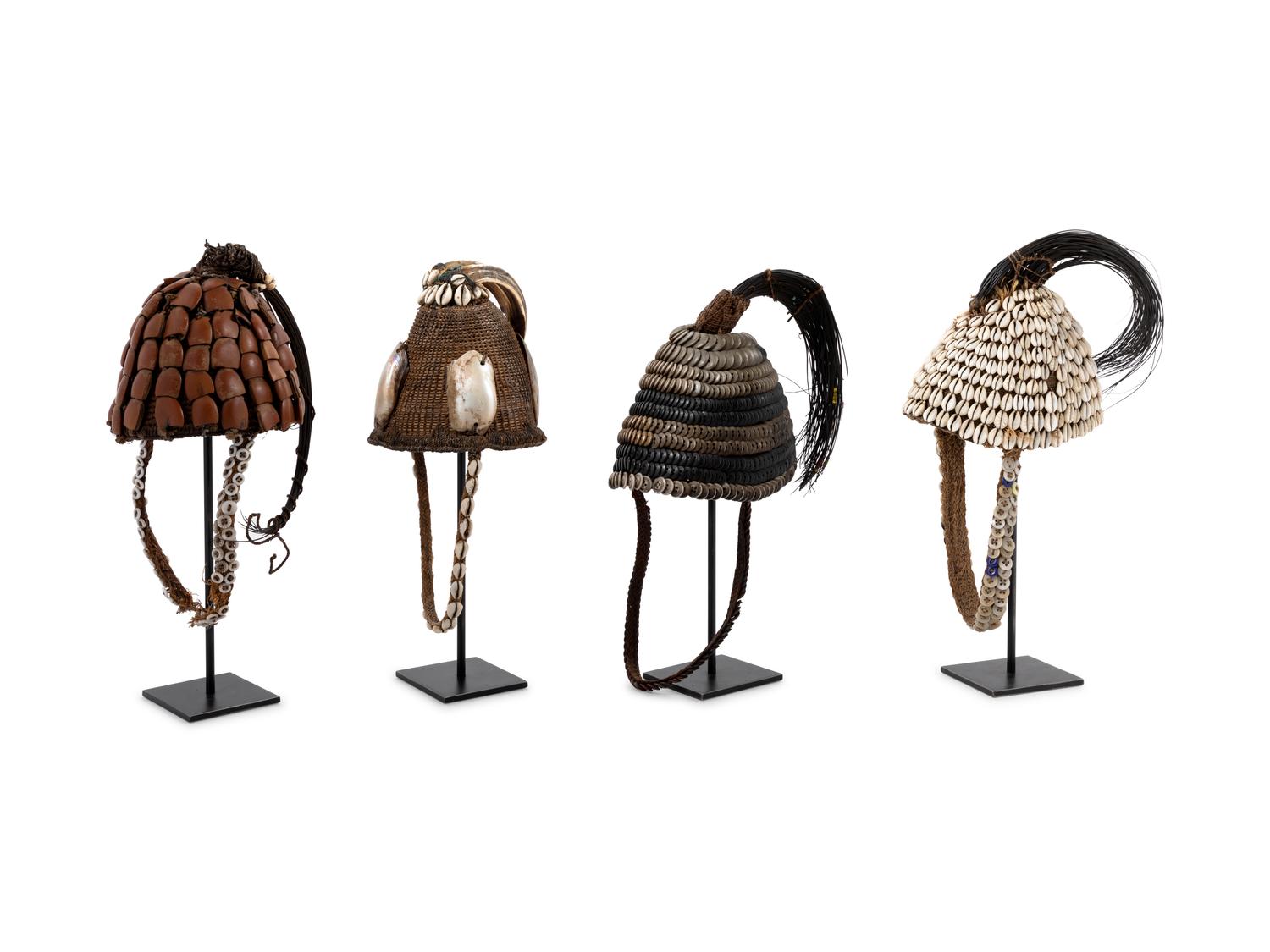 Seven Lega Headdresses and a Bamileke Quill Headdress