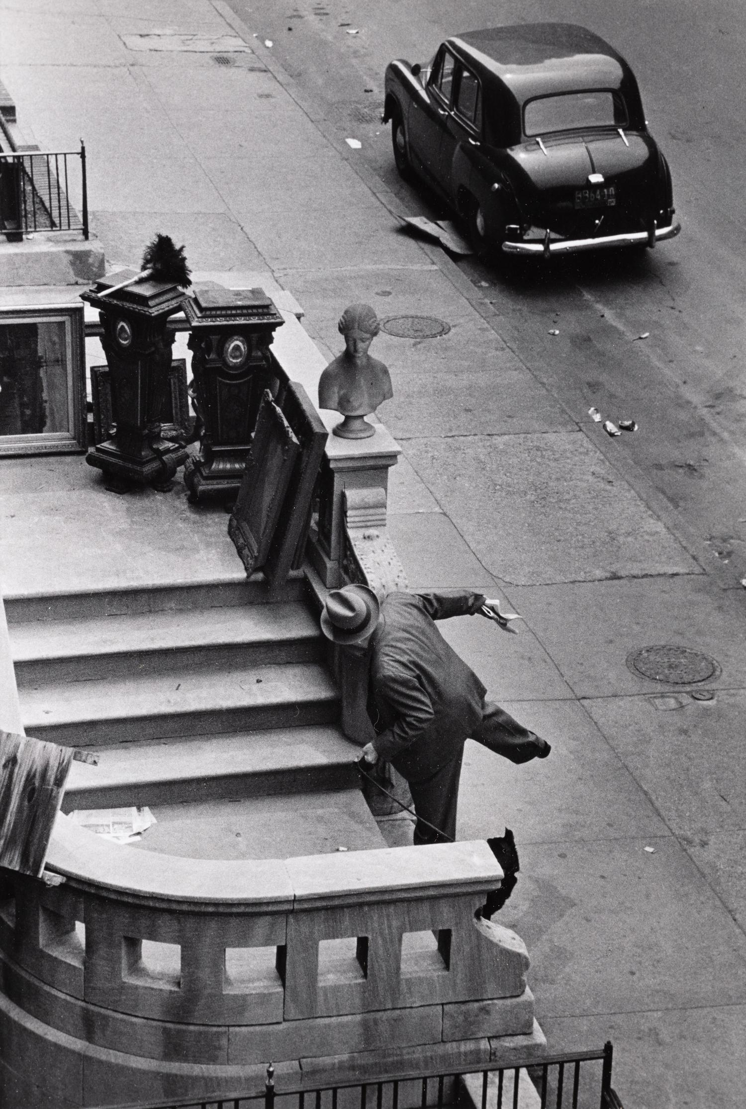 Ruth Orkin (1921-1985) Man Balancing on Stoop, West 88th Street, NYC, 1952