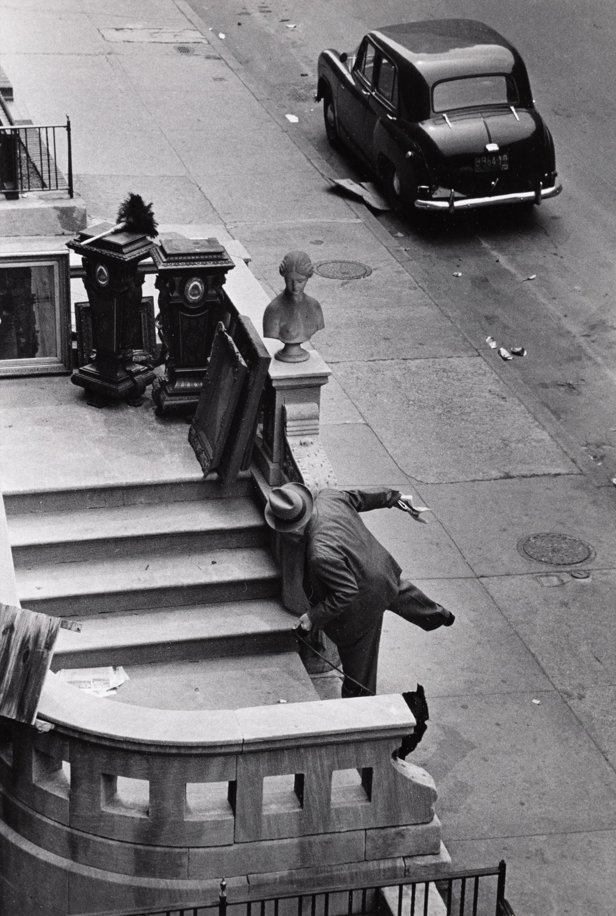 Ruth Orkin (1921-1985) Man Balancing on Stoop, West 88th Street, NYC, 1952