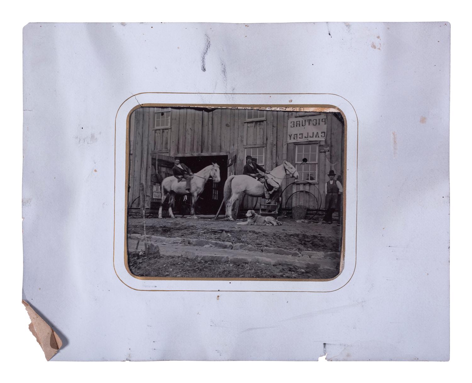 [EARLY PHOTOGRAPHY]. Half plate tintype of men, horses, & a dog outside of a "Picture Gallery."